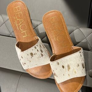 Cowhide, leather with gold accent.